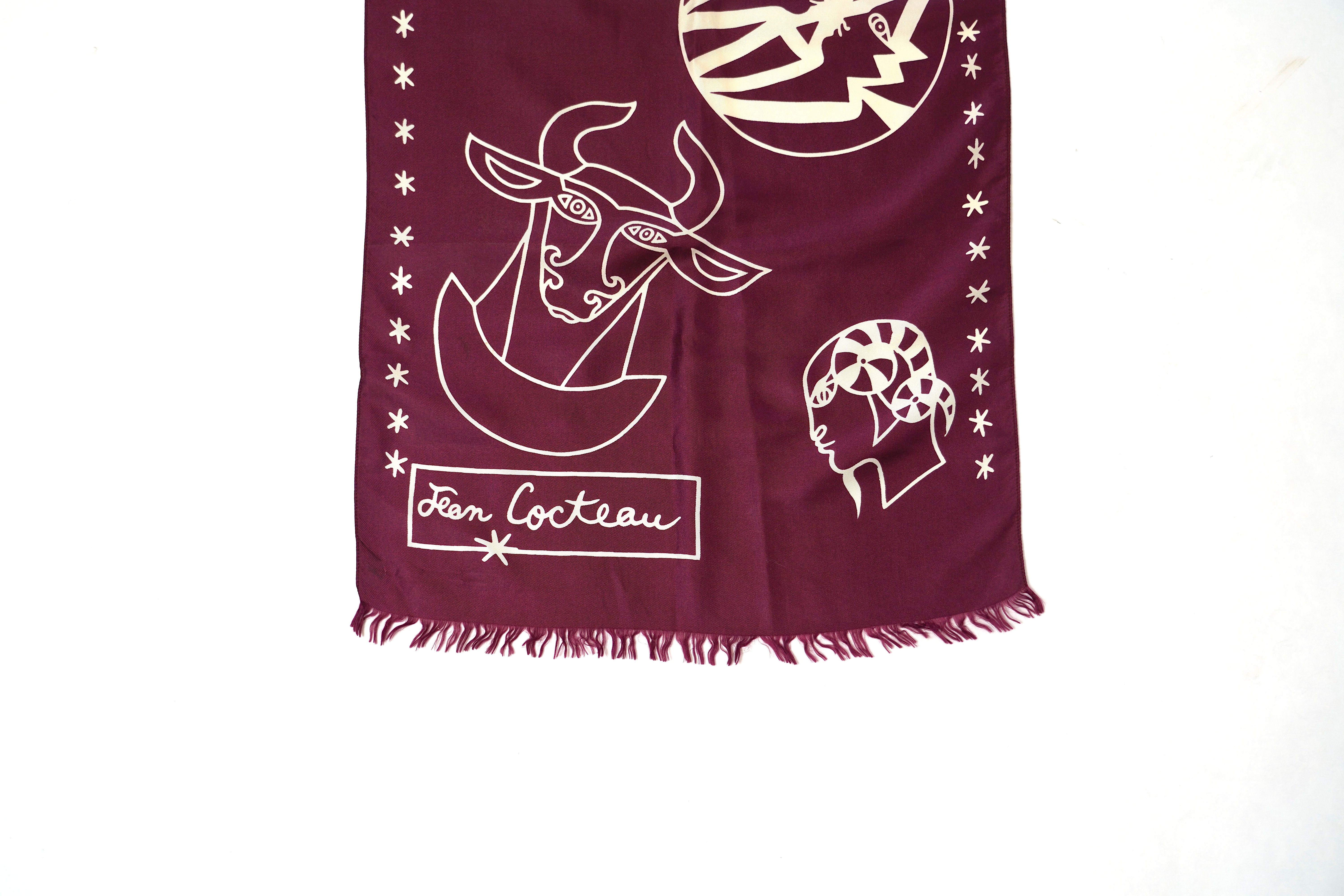 A Yves Saint Laurent silk scarf, a Jean Cocteau zodiac design silk scarf and a Rodier silk scarf.